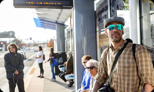 Bus Riders waiting at transit stop