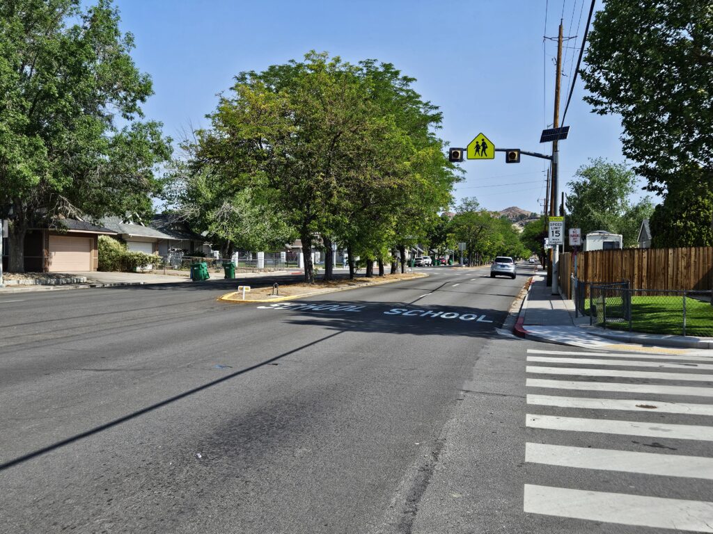 Roadway with school sign on Rock Blvd